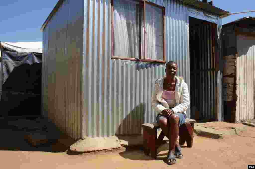 Maureen Mabuza experienced a "mirculous recovery" with anti-retroviral treatment. She sits in front of her one-room shack. (Photo by Darren Taylor)