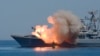Missiles are fired by a Russian navy battleship during a rehearsal of the Russian Navy Day parade in Sevastopol, Crimea, Ukraine. Friday, July 24, 2015. (AP Photo/Alexander Polegenko)