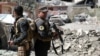 Iraqi Counter-Terrorism Services (CTS) secure a street near the old city in west Mosul on June 3, 2017, during their ongoing battle to retake the city from Islamic State (IS) group fighters.