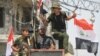 FILE - Iraqi soldiers celebrate their victory over IS militants in Mosul as battles continue in the Old City, July 12, 2017. 