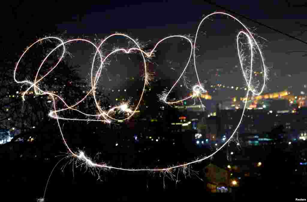 A girl with sparkle writes 2020 during the New Year's celebrations in North Macedonia.