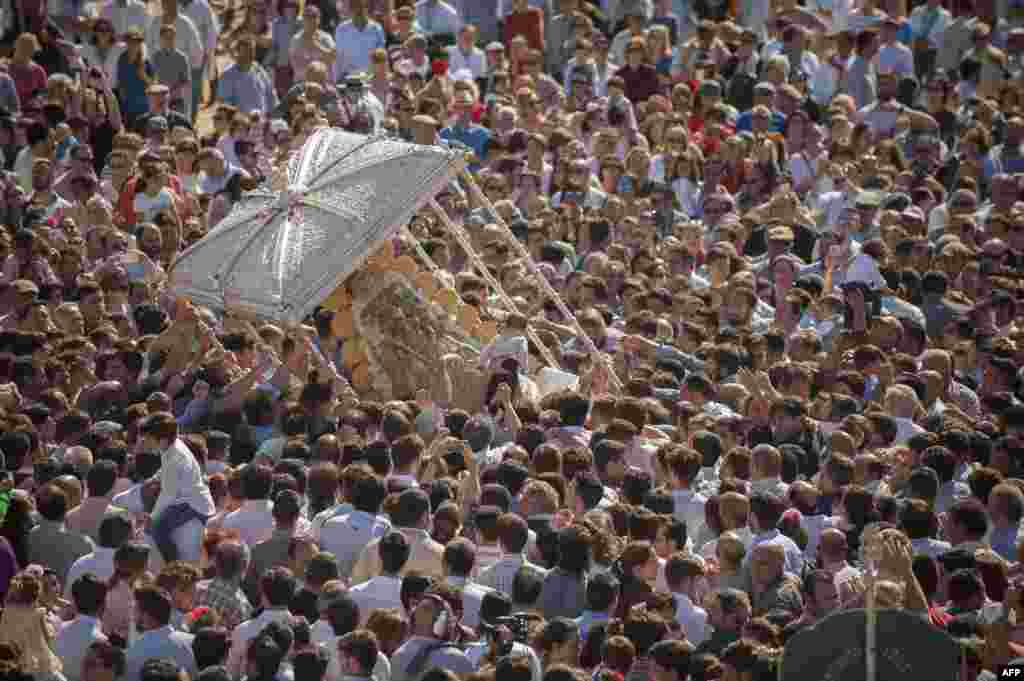 Pilgrims gather around a statue of the Virgin Mary during a procession in the village of El Rocio, southern Spain.