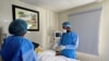 FILE - Doctor Oluwajoba Oroge attends to a patient at EHA Clinics in Abuja, Nigeria, Jan. 14, 2021.