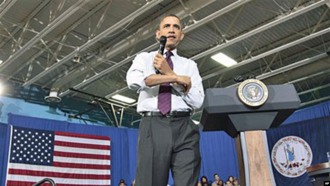 President Barack Obama rolls up his sleeves during a town hall meeting to discuss reducing the national debt at Northern Virginia Community College in Annandale, Va., April 19, 2011
