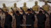 FILE - Islamic State militants stand behind what are said to be Ethiopian Christians in Libya, in this still image from an undated video posted to a social media website on April 19, 2015.