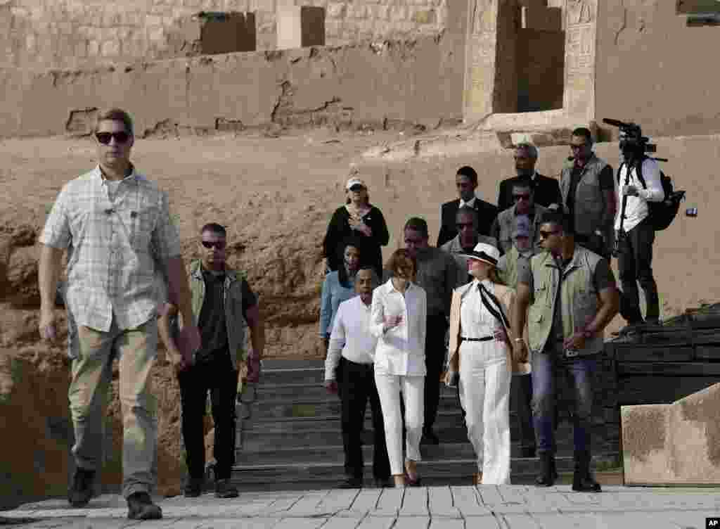 First lady Melania Trump, center arrives at the ancient statue of Sphinx, with the body of a lion and a human head, at the historic site of the Giza Pyramids, in Egypt, Oct. 6, 2018.
