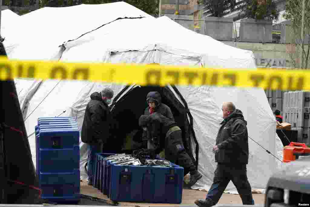 Workers construct what is believed to be a makeshift morgue behind a hospital during the outbreak of coronavirus, in the Manhattan borough of New York City.