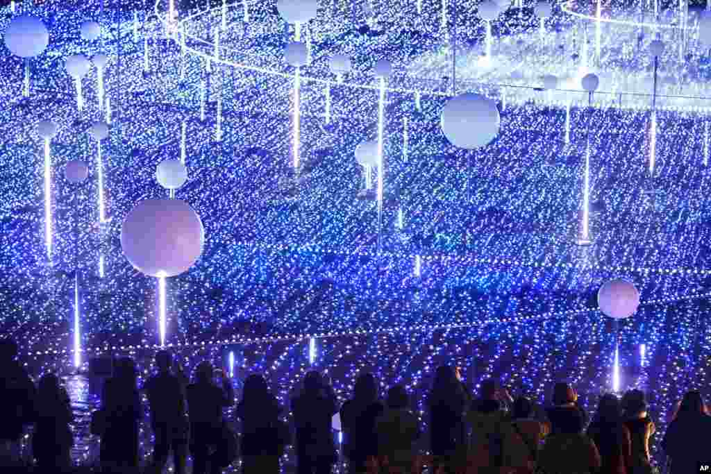 Spectators watch a Christmas lights display in the Minato district of Tokyo.