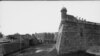 Tourists atop masonry wall look down on the water battery at Fort Marion, St. Augustine, Fla. Photo ca 1800-1897 by Wm. Henry Jackson.