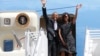U.S. President Barack Obama and the First lady Michelle Obama wave from Air Force One upon their departure from Dar es Salaam, July 2, 2013. 