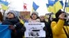 A protester holds a placard during a demonstration in support of Ukraine during a Foreign Affairs Council meeting at the EU headquarters in Brussels on January 23, 2023. (Photo by John THYS / AFP)