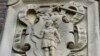 FILE - Relief panel on Johnston Gate, Harvard University's first and largest gate heading to the campus, in Cambridge, Mass., May 23, 2021.