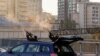 Police officers shoot at a drone during a Russian drone strike, which local authorities consider to be Iranian-made Shahed-136 unmanned aerial vehicles (UAVs), in Kyiv, Oct. 17, 2022. 