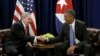 FILE - U.S. President Barack Obama (R) and Cuban President Raul Castro shake hands at the start of their meeting at the United Nations General Assembly in New York, Sept. 29, 2015.