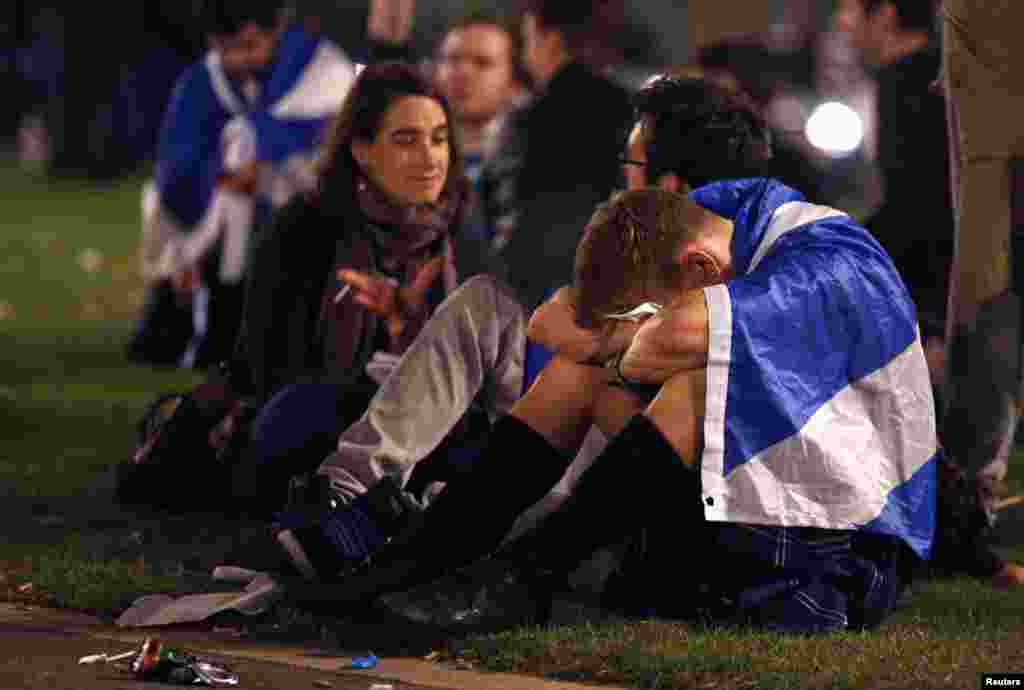 Supporters from the "Yes" Campaign react to the vote as they sit in George Square in Glasgow, Scotland, Sept. 19, 2014.