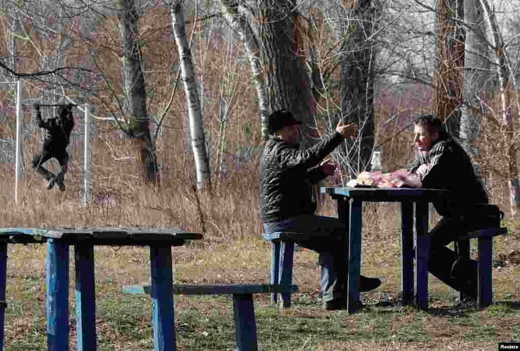 Men talk as they share a meal in the village of Novi Sanzhary, where the evacuees from coronavirus-hit China's Hubei province are quarantined at a sanatorium, in Poltava region, Ukraine.