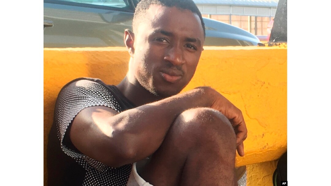 Mamadou Aliou Barry, who departed from his native Guinea in West Africa when he was 14, a few years ago, waits for entry to the U.S. on the Gateway Bridge in Matamoros, Mexico, which connects to Brownsville, Texas, July 3, 2018. He said as part of the minority ethnic Fula group, he fears for his life and carries prints of a picture of him and a friend together and a picture of his friend after he was slain, for his asylum interview.