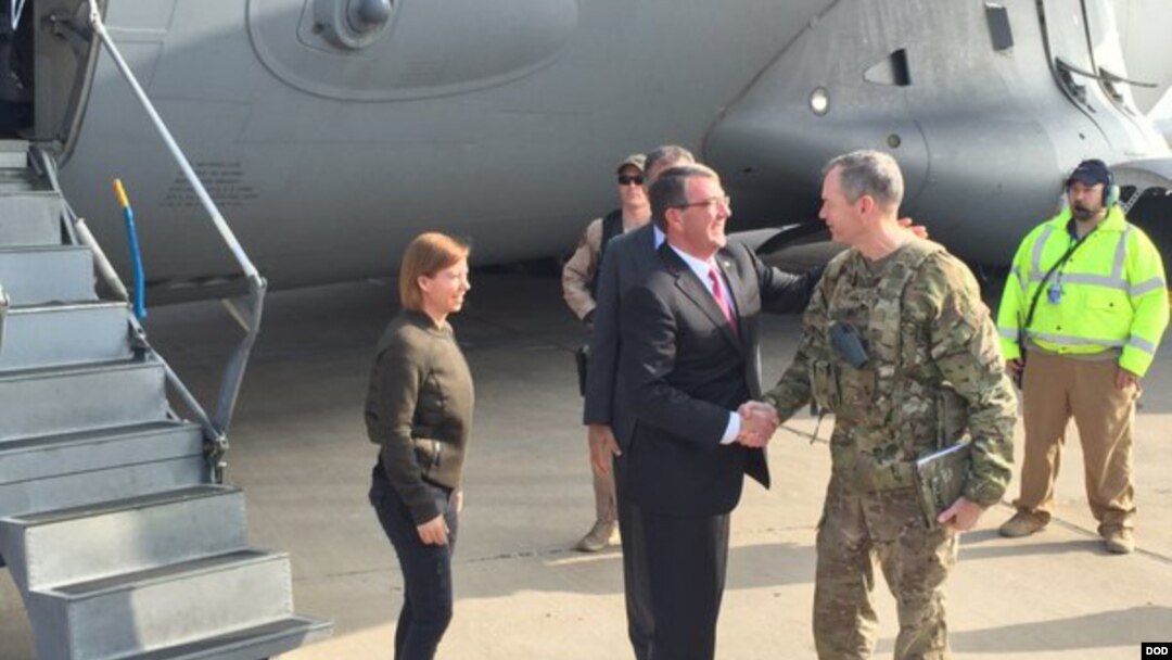 FILE - Army Lt. Gen. Sean MacFarland greets U.S. Defense Secretary Ash Carter after arriving in Baghdad, Dec. 16, 2015. MacFarland says end of IS is ‘a matter of time’ and more help."