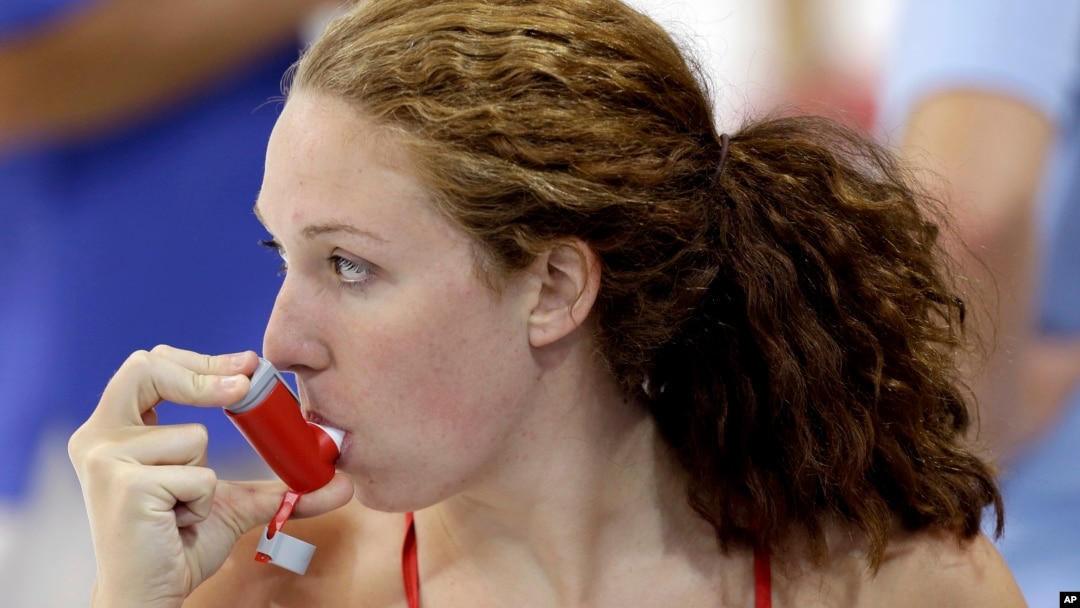 FILE - U.S. swimmer Shannon Vreeland uses an inhaler during a practice session ahead of the 2012 Summer Olympics, in London, July 26, 2012.