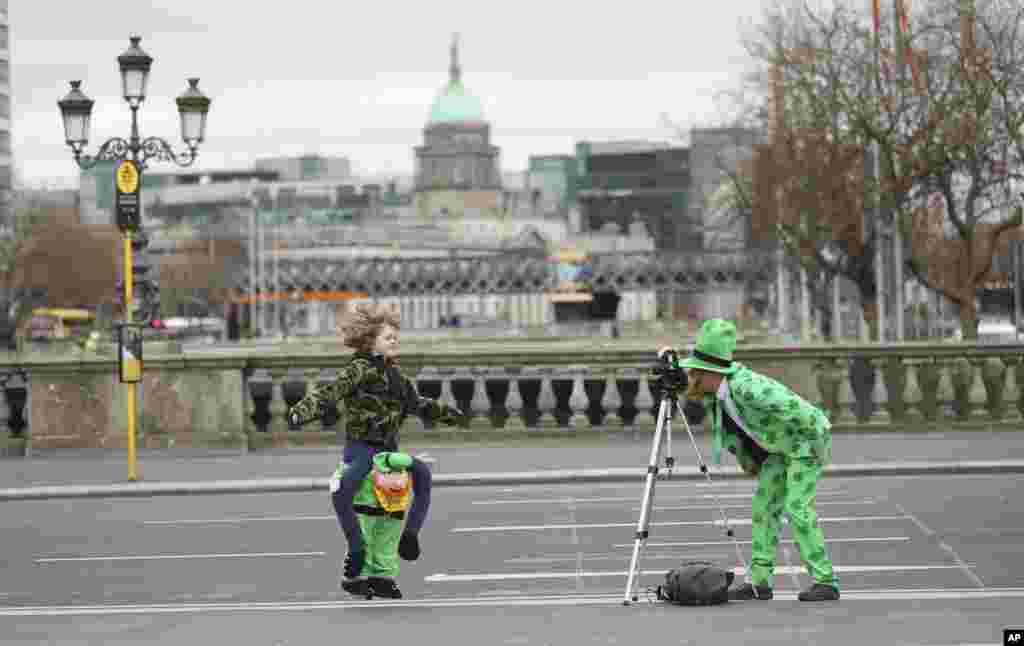 People dressed up for St. Patricks Day take a picture in Dublin city center, Ireland.