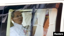 Thailand's King Bhumibol Adulyadej sits in a vehicle as he leaves Siriraj Hospital for the Grand Palace to join a ceremony marking Coronation Day in Bangkok, Thailand, May 5, 2015.