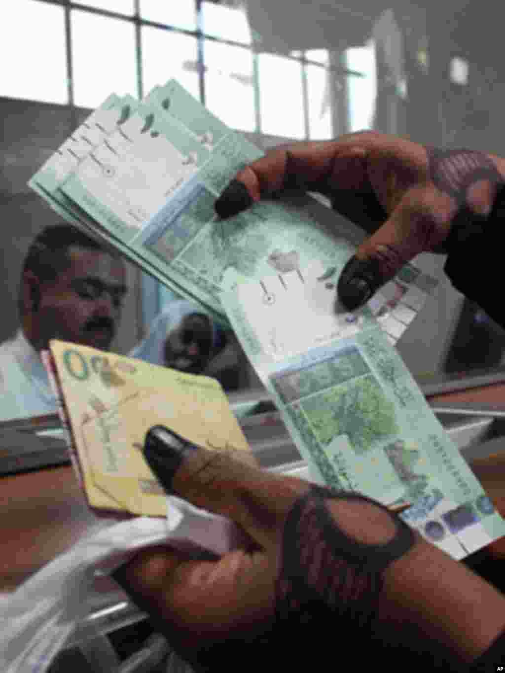 President Kiir should know the difference between cows and money. How come he kept money in his compound like cows and yet we have safe places like banks for him to save his save his money? Keeping money in the office is a sign of corruption. - James Ruei Majok in Unity state A woman displays Sudan's new currency at the central bank in Khartoum, Sudan, in July 2011.