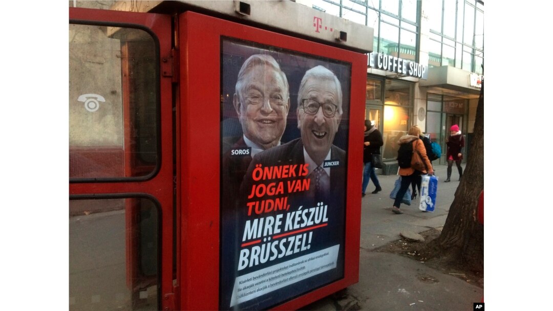 A phone box displays a billboards showing Hungarian-American financier George Soros and EU Commission President Jean-Claude Juncker above the caption “You have a right to know what Brussels is preparing to do!," on Vaci Avenue in Budapest, Hungary, Feb. 19, 2019.