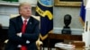 President Donald Trump listens during a meeting with North Korean defectors where he talked with reporters about allowing the release of a secret memo on the FBI's role in the Russia inquiry, in the Oval Office of the White House, Feb. 2, 2018, in Washington.