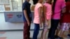 FILE - Detained immigrant children line up in the cafeteria at the Karnes County Residential Center, a temporary home for immigrant women and children detained at the border, in Karnes City, Texas, Sept. 10, 2014. 