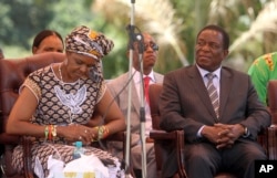 FILE - Zimbabwean then-first lady Grace Mugabe (L) sits next to Emmerson Mnangagwa at the ZANU-PF headquarters in Harare, Feb, 10, 2016.