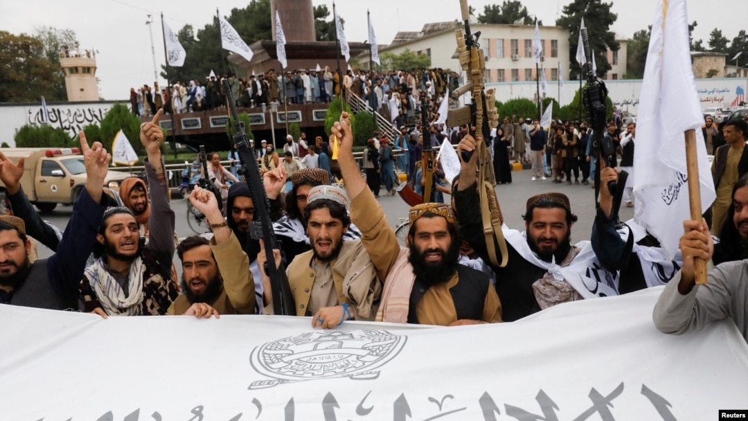 Taliban fighters celebrate the first anniversary of the fall of Kabul