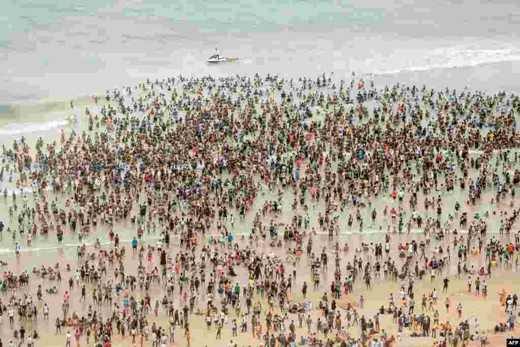 Thousands of New Year's day revelers and holidaymakers gathering on North Pier Beach during New Year festivities in Durban, South Africa.
