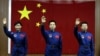 Chinese astronauts Jing Haipeng (C), Liu Wang (R) and Liu Yang, China's first female astronaut, wave to the media during a news conference at Jiuquan Satellite Launch Center, in northwest China's Gansu province, June 15, 2012. 