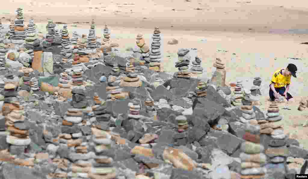 Pebble sculptures are seen on Whitley Bay beach, Britain.