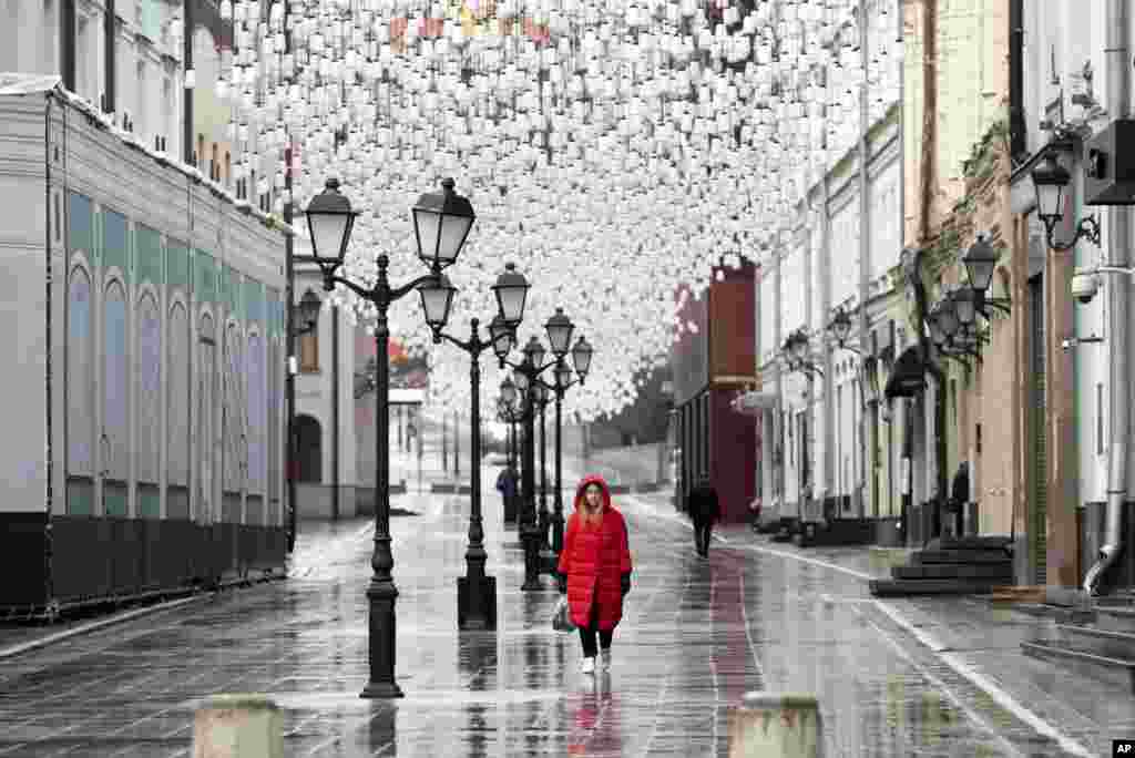 A woman walks through an almost empty pedestrian street in Moscow, Russia. President Vladimir Putin ordered most Russians to stay off work until the end of April as part of a partial economic shutdown to stymie the spread of the coronavirus.