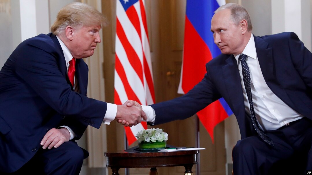 FILE - In this Monday, July 16, 2018, file photo, U.S. President Donald Trump, left, and Russian President Vladimir Putin shake hands at the beginning of a meeting at the Presidential Palace in Helsinki, Finland.