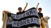 FILE - Pro-democracy activists chant slogans on the Golden Bauhinia Square, a gift from China at the 1997 handover, during a protest a day before Chinese President Xi Jinping is due to arrive for the celebrations, in Hong Kong, China, June 28, 2017. 