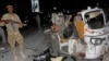 FILE - A Somali soldier stands guard near a destroyed auto rickshaw after a car bomb was detonated in Mogadishu, Somalia, Aug 4, 2017. At least three people were killed in the blast. On Aug. 10, another car bomb blast injured three people in the city.