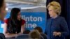 FILE - Democratic presidential candidate Hillary Clinton speaks with senior aide Huma Abedin aboard her campaign plane at Westchester County Airport in White Plains. 