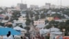 FILE - People walk along a street in Mogadishu, Sept. 28, 2013. 