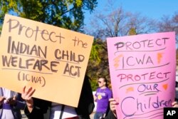FILE - Demonstrators standing outside the U.S. Supreme Court in Washington, Nov. 9, 2022, as Justices heard arguments over the Indian Child Welfare Act.