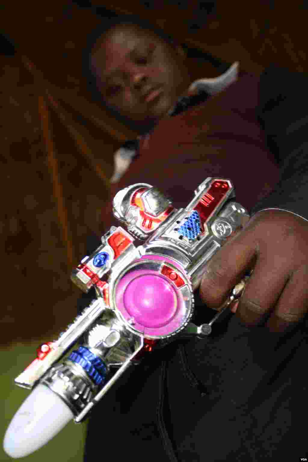 Sihle with his favorite toy – a battery operated toy space gun (VOA/ D. Taylor)