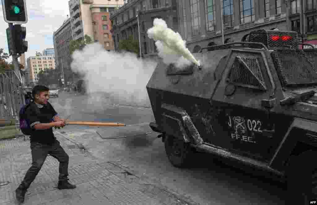 A student confronts riot police during a protest against Chile's President Sebastian Pinera government, in Santiago.
