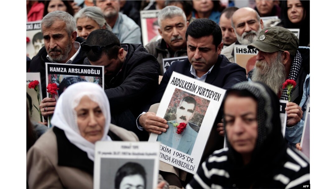 FILE - Selahattin Demirtas (C), co-leader of Turkey's pro-Kurdish Peoples' Democratic Party (HDP), attends a gathering of "Saturday Mothers" at Galata Sarai Square in Istanbul, Oct. 31, 2015, on the eve of the country's general election.