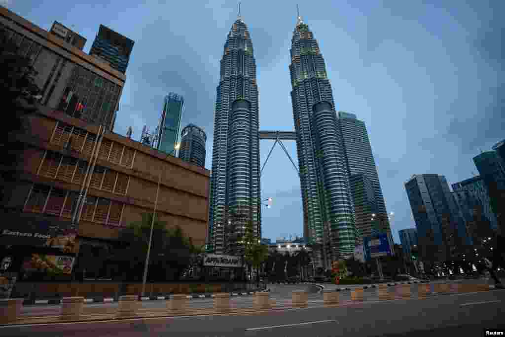 An empty street is seen in front of Petronas Twin Towers after Malaysia's government announced the movement control order due to the spread of the coronavirus in Kuala Lumpur, Malaysia.