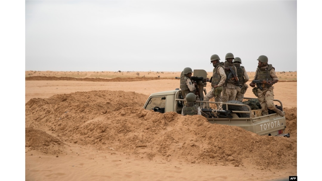 FILE - Soldiers of the Mauritania Army wait in an armed vehicle at a G5 Sahel task force outpost in the southeast of Mauritania, along the border with Mali, Nov. 22, 2018.