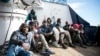 Migrants sit on the deck of the Sea-Eye rescue ship in the Mediterranean Sea, Jan. 8, 2018. Two German nonprofit groups are appealing to European Union countries to take in 49 migrants whose health is deteriorating while they are stuck on rescue ships in the Mediterranean Sea.