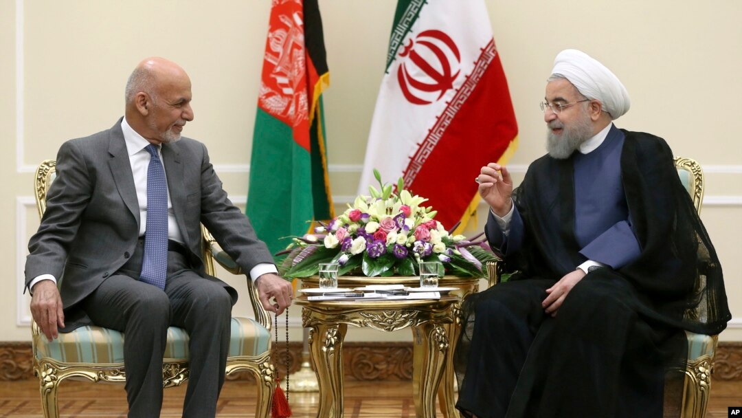 Iranian President Hassan Rouhani, right, talks with his Afghan counterpart Ashraf Ghani at his office in Tehran, Iran, Aug. 5, 2017. 