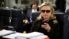 FILE - In this Oct. 18, 2011, file photo, then-secretary of state Hillary Clinton checks her Blackberry from a desk inside a C-17 military plane.