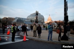 Personas en Washington, D.C., observan el paso de la carroza fúnebre con el cuerpo del expresidente George H.W. Bush, de camino al Capitolio para ceremonias fúnebres hasta el miércoles 5 de diciembre. Diciembre 3 de 2018.